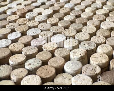 Many clean and new wine corks are shown on display up close in a diagonal view. Stock Photo