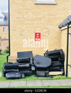 Fly tipping under “No Fly Tipping” sign on an estate in Sutton, London Stock Photo