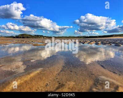 Cumulus clouds reflected in a tidal pool, late October, Camel estuary, near Padstow, England. Stock Photo