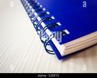 Close up of a spiral diary with blue cover Stock Photo