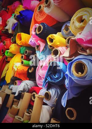 Colorful rolls of fabric and a retail fabric store in the garment District, New York City, USA Stock Photo