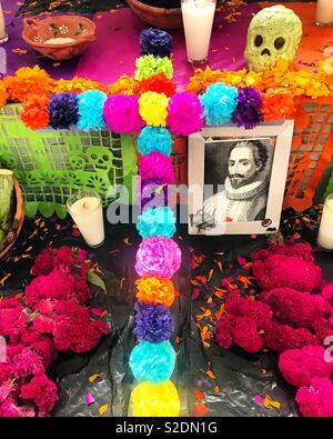 A cross made with paper flowers and a portrait of a deceased historic Mexican decorate an altar during Day of the Dead celebrations in Coyoacan, Mexico Stock Photo