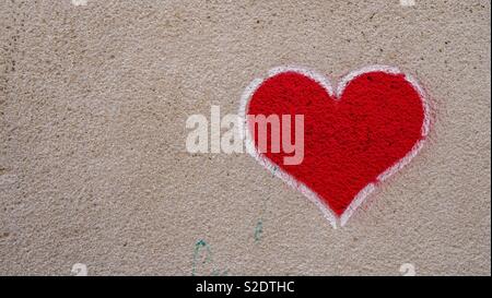 Heart shaped graffiti on a concrete wall in Valencia Stock Photo