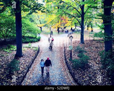 NYC A couple and other New Yorkers enjoying central park near Glade arch on an autumn afternoon, NYC, USA Stock Photo