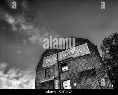Take Courage Advert on What used to be The Courage & Co. Ltd Brewery in Southwark London in England Stock Photo