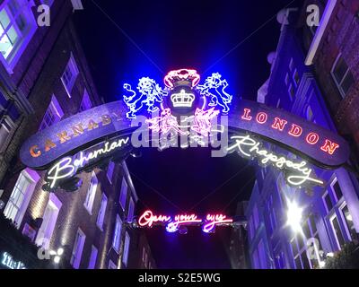 Carnaby Street, London presents a neon bohemian rhapsody display to promote the new film. Stock Photo