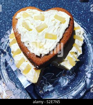 Pineapple heart cake with a piece missing Stock Photo