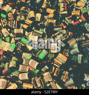 Old analogue 35mm film cassettes background - old film stock Stock Photo