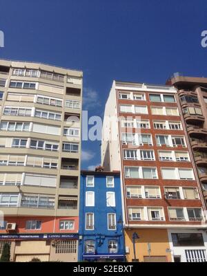 A small building is squashed by tall buildings in Santander Spain Stock Photo