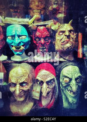 Ghoulish masks in a window display. It must be Halloween Time. Not recommended for people with a nervous disposition! Photo Credit - © COLIN HOSKINS. Stock Photo