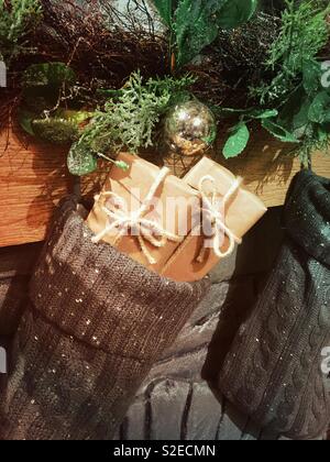 Stockings filled with presents on a decorative holiday fireplace mantle, USA Stock Photo
