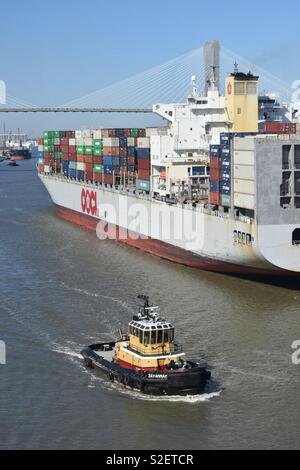 Container ship and tug boat on the Savannah River Stock Photo