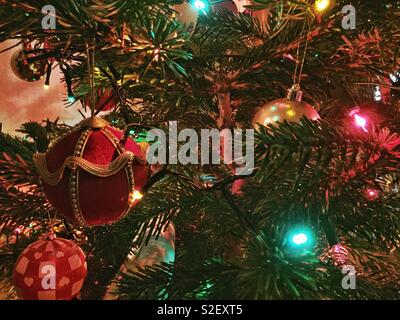 Baubles and fairy lights on a Christmas tree. Stock Photo