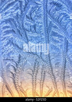 Patterns in frost covered window Stock Photo