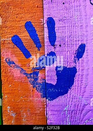 Blue handprint on painted boards Stock Photo