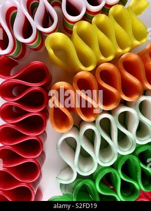 Brightly colored ribbon candy on a white background Stock Photo