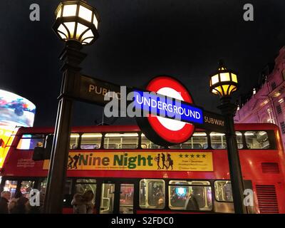 London Underground sign in Piccadilly Circus at night Stock Photo