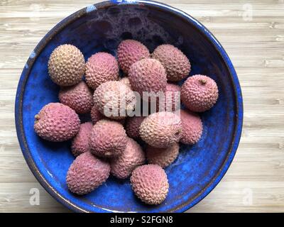 Lychees in a blue ceramic bowl Stock Photo