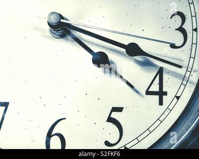 Close up view of hands on an analogue clock. Stock Photo