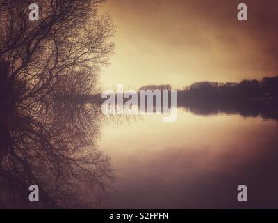 Mist over Rivington reservoir early in morning Stock Photo