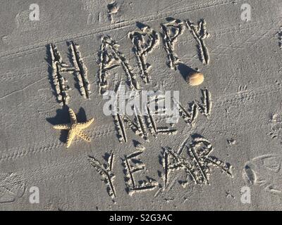 Happy New Year written in the sand at Ponte Vedra Beach, Florida on New Year’s Day Stock Photo