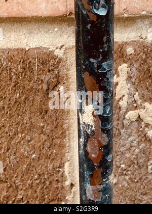 Rusting pipe on the wall Stock Photo