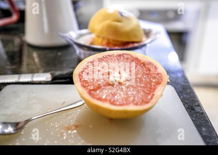 Squeezing fresh grapefruit juice Stock Photo