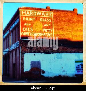 Old building with hand-painted sign on brick wall Stock Photo