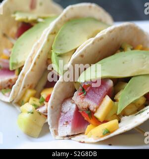 Ahi tuna fish tacos with fresh avocado and mango salsa Stock Photo