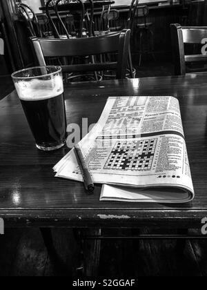 A pint of beer and the crossword. Glasgow. Scotland. UK. Stock Photo