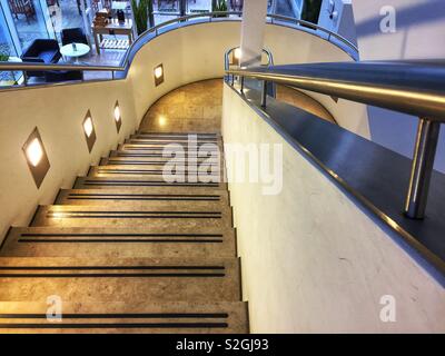 A marble staircase leading downwards in an office building. Stock Photo