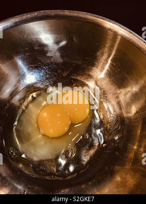 Double yolk egg in a stainless steel bowl Stock Photo