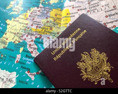 Close up of a French / European passport on an old map of Europe. Stock Photo