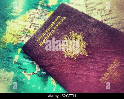 French passport on a old map of Europe, with a grunge effect. Stock Photo