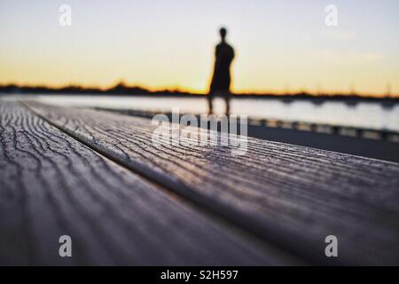 Eye level shot of the grains on an old wooden bench overlooking the foreshore in Mandurah, Western Australia. Stock Photo