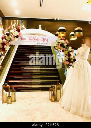 A wedding story, wedding fair with wedding dress and flowers Stock Photo