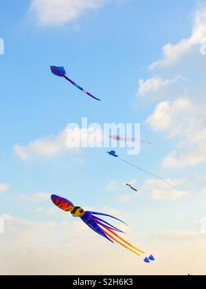 Colourful squid shaped kites flying over Walmer beach, Kent, UK Stock Photo