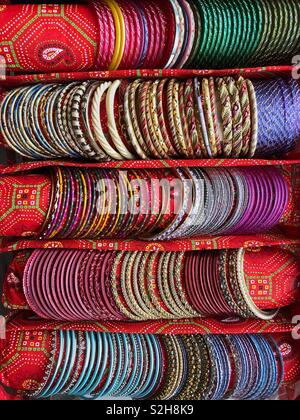 Rows of colourful Indian bangles on display in a specially made carry case. Stock Photo