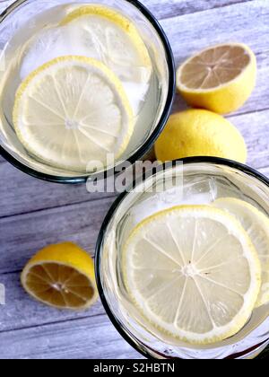 Top view of two ice cold glasses of lemonade on a wooden table Stock Photo