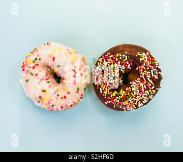 Top down shot Two sprinkle donuts one chocolate and one vanilla. Stock Photo