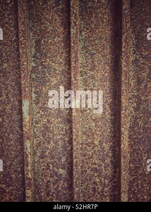 Rusted iron gate with a very worn surface. This close-up macro image is ...