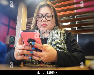 Asian woman using a mobile phone. Stock Photo