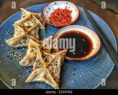 Chinese dumplings served with soya souse and chili Stock Photo