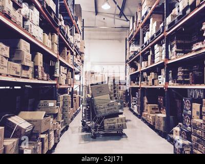 A warehouse with shelves stacked with cardboard boxes. Stock Photo