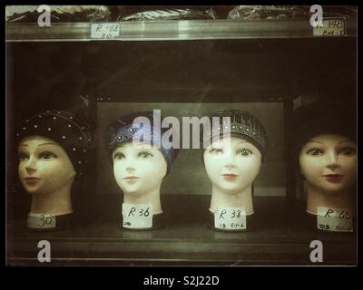 Row of mannequin heads with hats for sale. Stock Photo