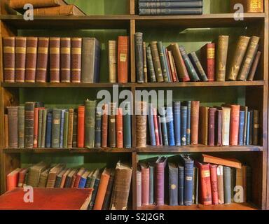 Old books in a book case Stock Photo