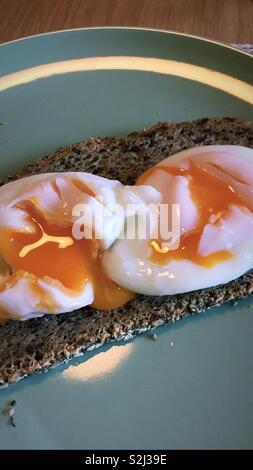Runny poached eggs Stock Photo