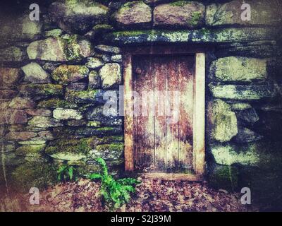 Old wooden doorway in an old stone barn, St Fagans Museum of Welsh Life. Stock Photo