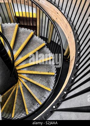 Abstract formed by looking down a metal, spiral staircase Stock Photo