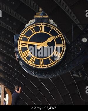 The historic large railway station clock at York, UK. This noted, large historic station between London and Edinburgh opened in 1877, then the largest world station. It is a Grade II listed building. Stock Photo